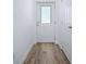 Bright hallway features wood-look floors, neutral walls, and white doors and trim at 2741 S Brown Ave, Orlando, FL 32806