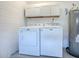 Garage Laundry Area with white washer and dryer, utility sink, and shelving at 2741 S Brown Ave, Orlando, FL 32806