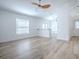 Open-concept living room with wood-look flooring, neutral walls, and lots of natural light at 2741 S Brown Ave, Orlando, FL 32806