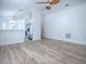 Open living room featuring wood-look floors, a ceiling fan, and views of the kitchen and dining area at 2741 S Brown Ave, Orlando, FL 32806