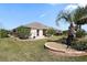Beautiful backyard featuring a landscaped lawn and decorative stone accents at 2947 Rain Lily Loop, The Villages, FL 32163