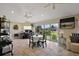 Bright dining area with tile floors and a view of the landscaped yard through large windows at 2947 Rain Lily Loop, The Villages, FL 32163