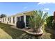 Home exterior featuring a covered porch with an outdoor grill, ideal for entertaining at 2947 Rain Lily Loop, The Villages, FL 32163