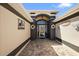 Arched front doorway with brick paved entrance and decorated walls for a warm and inviting appeal at 2947 Rain Lily Loop, The Villages, FL 32163