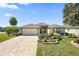Charming home featuring a well-maintained lawn, paved driveway and a two car garage at 2947 Rain Lily Loop, The Villages, FL 32163