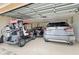 Spacious garage featuring a golf cart, Lexus RX and other car, providing ample parking and storage at 2947 Rain Lily Loop, The Villages, FL 32163