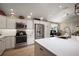 Well-lit kitchen featuring stainless steel appliances, custom cabinetry, and a large center island at 2947 Rain Lily Loop, The Villages, FL 32163