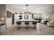 Spacious kitchen with a large center island, stainless steel appliances, and modern light fixtures at 2947 Rain Lily Loop, The Villages, FL 32163