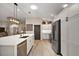 Open kitchen with a large center island, stainless steel appliances, and plenty of cabinet space at 2947 Rain Lily Loop, The Villages, FL 32163