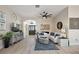Inviting living room with comfortable seating, modern decor, and ample natural light at 2947 Rain Lily Loop, The Villages, FL 32163