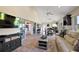Open concept living room features tile floors, vaulted ceilings, seamless flow to dining and kitchen at 2947 Rain Lily Loop, The Villages, FL 32163