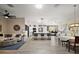 Spacious living room featuring hardwood floors and a modern, open floor plan connected to kitchen at 2947 Rain Lily Loop, The Villages, FL 32163