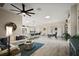 Bright open-concept living room boasts wood floors and an airy atmosphere with plentiful natural light at 2947 Rain Lily Loop, The Villages, FL 32163