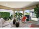 Relaxing sunroom featuring tile floors, bright sunlight, and comfortable seating for enjoying the weather at 2947 Rain Lily Loop, The Villages, FL 32163