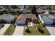 Aerial view of a well-maintained house showcasing landscaping, driveway, and surrounding neighborhood at 314 Olanta Dr, The Villages, FL 32162
