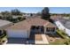 Drone view of a cozy house with a well-maintained lawn and landscape in a tranquil neighborhood at 314 Olanta Dr, The Villages, FL 32162