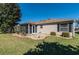 Well-maintained backyard featuring a screened-in porch, decorative rock beds and a tidy lawn at 314 Olanta Dr, The Villages, FL 32162
