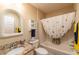 Bright bathroom features granite countertop, updated fixtures and shower-tub combination at 314 Olanta Dr, The Villages, FL 32162