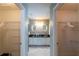 Modern bathroom featuring dual sinks, sleek mirrors, stylish lighting, and walk-in closets at 314 Olanta Dr, The Villages, FL 32162