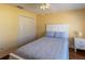 Comfortable bedroom featuring wood floors, a ceiling fan, and ample closet space at 314 Olanta Dr, The Villages, FL 32162