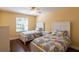 Sunny bedroom with two twin beds, ceiling fan, and wood floors offers a cozy retreat at 314 Olanta Dr, The Villages, FL 32162