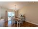 Elegant dining area with a wood table, seating for six, and sliding glass doors that lead to an outdoor patio space at 314 Olanta Dr, The Villages, FL 32162