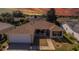 Charming home with a well-manicured lawn and inviting entrance, complemented by a two-car garage and landscaped garden beds at 314 Olanta Dr, The Villages, FL 32162