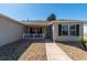 Inviting front porch with a pathway leading to the entrance, framed by a stone garden and a charming white picket fence at 314 Olanta Dr, The Villages, FL 32162