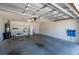 Spacious two-car garage with painted walls and utility sink offers ample storage at 314 Olanta Dr, The Villages, FL 32162