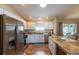 Bright kitchen featuring stainless steel appliances, granite countertops, white cabinetry, and a center island at 314 Olanta Dr, The Villages, FL 32162