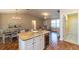 Open-concept living area with kitchen island, dining table, and comfortable seating at 314 Olanta Dr, The Villages, FL 32162