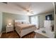Spacious main bedroom with wood floors, white furniture, and a large window at 314 Olanta Dr, The Villages, FL 32162