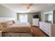 Comfortable main bedroom with a large window, wood floors, and a ceiling fan at 314 Olanta Dr, The Villages, FL 32162