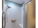 Shower featuring glass doors, white tile and a shower bench at 314 Olanta Dr, The Villages, FL 32162