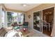 Enjoy the sunroom with wicker furniture overlooking the dining room through glass windows at 314 Olanta Dr, The Villages, FL 32162
