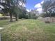 Spacious backyard with mature trees, a well-maintained lawn, and a wooden fence surround at 3309 Ne 16Th Ave, Ocala, FL 34479