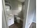 Bathroom featuring a walk-in shower, vanity, tiled walls and wood-look flooring at 3309 Ne 16Th Ave, Ocala, FL 34479