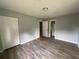 Inviting bedroom with laminate flooring, neutral walls, closet, and access to the bathroom at 3309 Ne 16Th Ave, Ocala, FL 34479