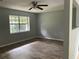 Spacious bedroom featuring laminate flooring, neutral walls, a ceiling fan, and a bright window at 3309 Ne 16Th Ave, Ocala, FL 34479