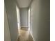 Clean hallway with tile flooring, neutral walls, and multiple doorways leading to other rooms at 3309 Ne 16Th Ave, Ocala, FL 34479