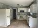 Cozy kitchen featuring white cabinetry, appliances, tile floors, and ample counter space at 3309 Ne 16Th Ave, Ocala, FL 34479