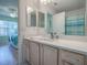 Bright bathroom features a quartz countertop, modern faucet, and natural wood cabinets offering style and functionality at 3337 Ashbrook Pl, The Villages, FL 32162