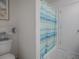 Clean bathroom features a tiled floor, decorative wall art, and white door at 3337 Ashbrook Pl, The Villages, FL 32162
