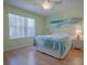 Serene bedroom featuring hardwood floors, a ceiling fan, and plenty of natural light at 3337 Ashbrook Pl, The Villages, FL 32162