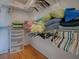Organized walk-in closet with shelves for clothing, pillows, and personal items, maximizing storage space at 3337 Ashbrook Pl, The Villages, FL 32162