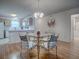 Cozy dining area featuring a glass table with seating for four and seamlessly connected to the kitchen at 3337 Ashbrook Pl, The Villages, FL 32162