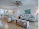 Bright living room with a ceiling fan and hardwood floors that connect to the dining area at 3337 Ashbrook Pl, The Villages, FL 32162