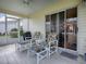Relaxing screened-in patio with tiled floor, ceiling fan, and sliding glass door to the outside at 3337 Ashbrook Pl, The Villages, FL 32162