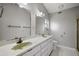 Bathroom features a double vanity, large mirrors, and white cabinets at 33624 Dolores Ct, Leesburg, FL 34788
