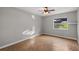 Bedroom with parquet floors, a ceiling fan, and a large window at 33624 Dolores Ct, Leesburg, FL 34788